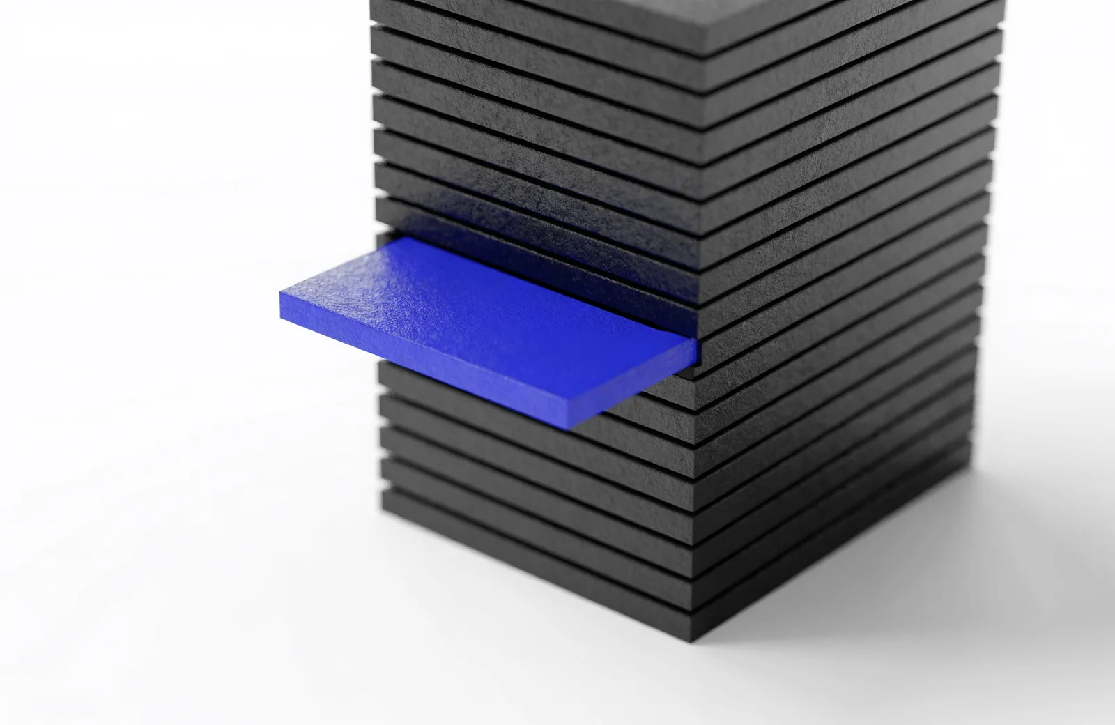 A stack of black layers with one blue layer slid partly out like a drawer, the layers above and below undisturbed.