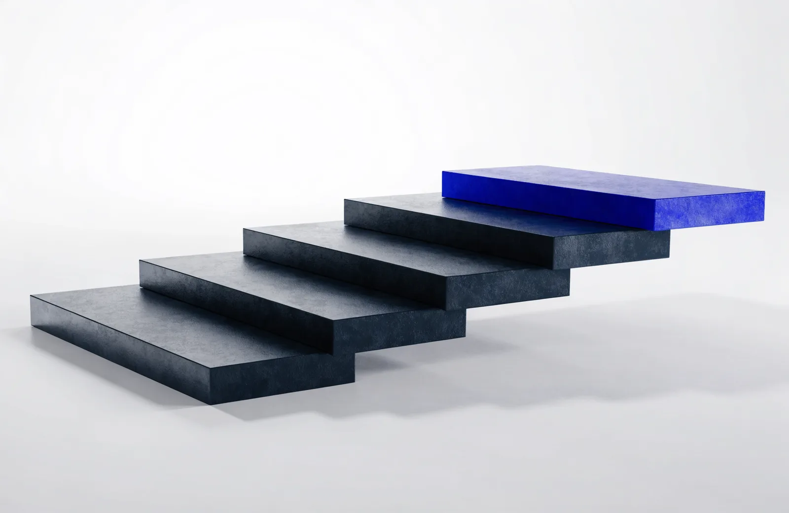 Six black slabs arranged as an ascending staircase, the final highest slab blue.